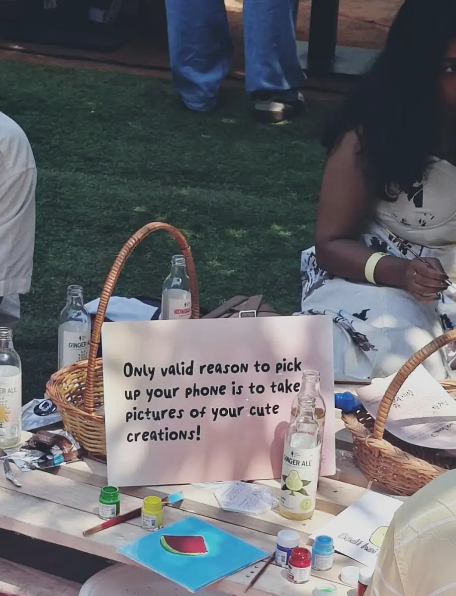 Sign at the Picnic Rave reading that the only reason to pick up your phone is to photograph your creations