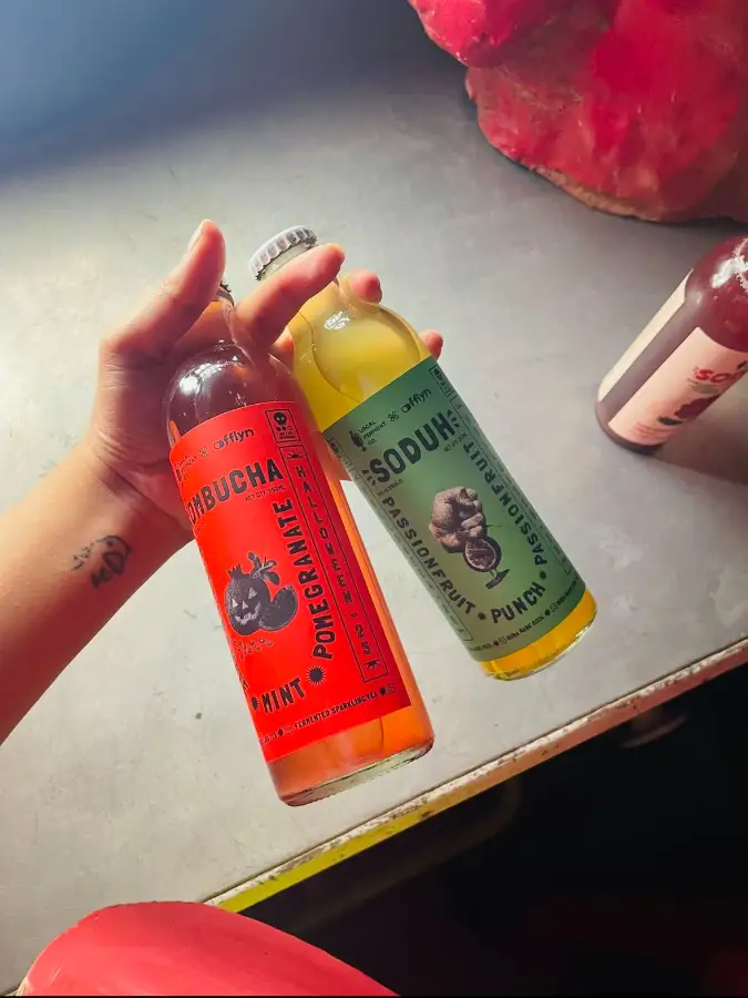 Two bottles raised at an event