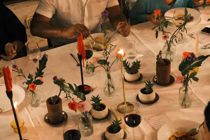 A candlelit dinner table set for guests