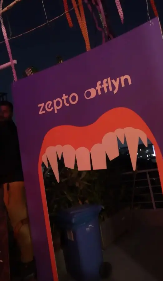 A Zepto and Offlyn branded photo wall at an event