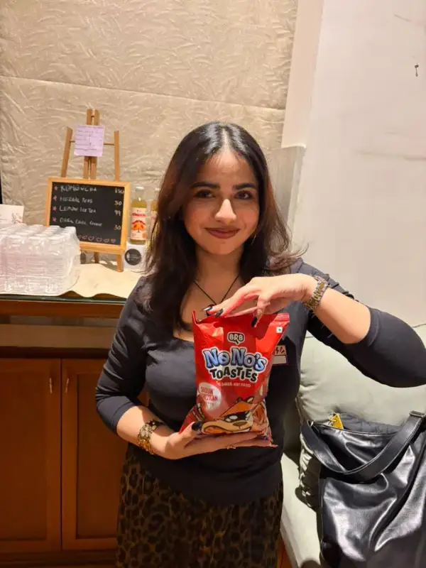 A guest holding up a snack pack at an event
