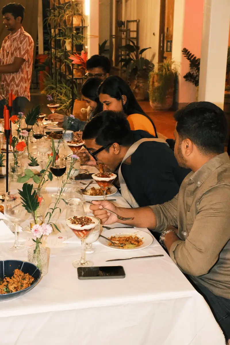 Guests at a long-table supper club